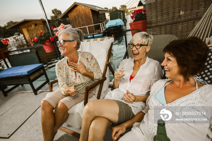 Senior female friends enjoying a day in the cottage near the river