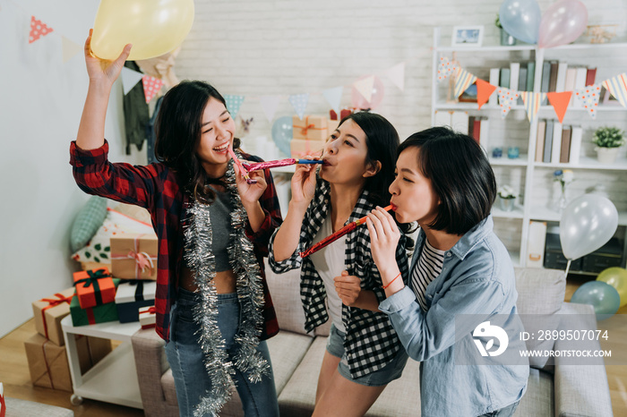 young girls celebrating graduation party in house