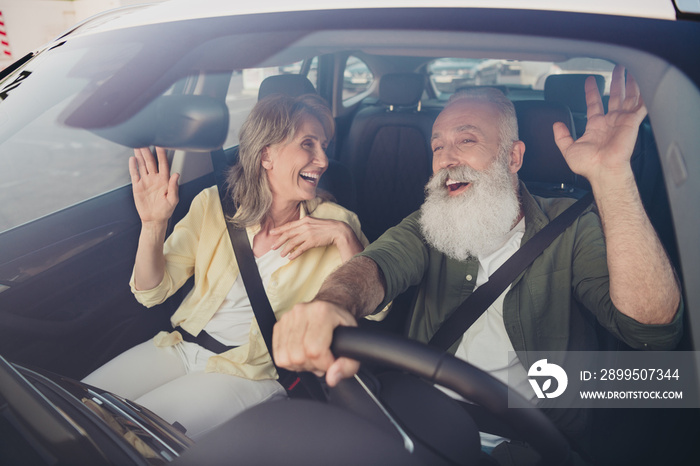 Portrait of attractive cheerful couple riding car having fun singing song spending vacation holiday day good mood