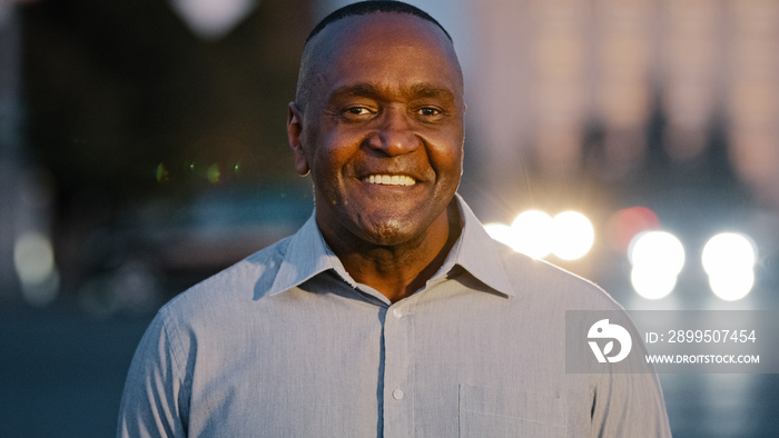 Close up male portrait in city outdoors African American adult middle-aged man posing on street happy smiling guy face with wrinkles successful mature businessman ethnic boss leader looking at camera