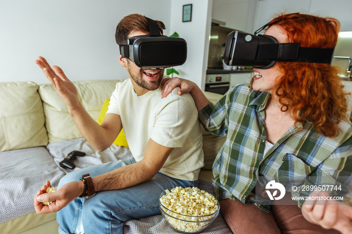 Virtual journey. Couple in casual clothes wear the virtual reality glasses are watching and showing imagine via the VR camera