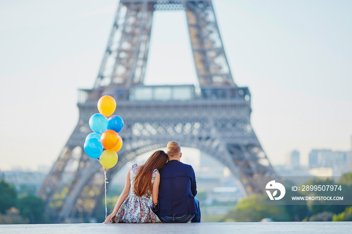 Couple with colorful balloons near the Eiffel tower