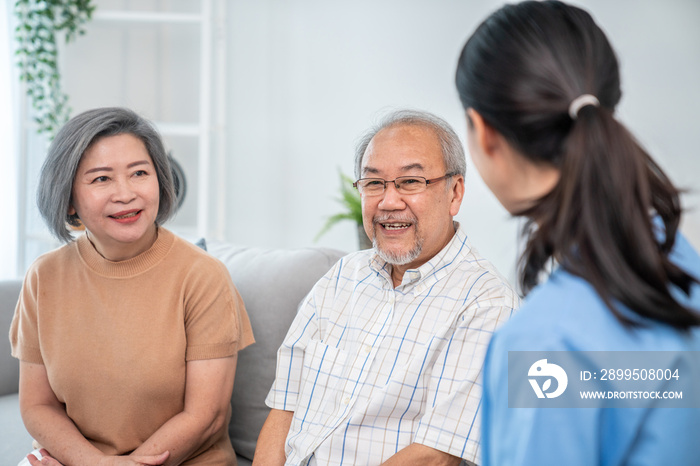 Female doctor visiting a contented elderly couple at their home. Health care, senior health support staff.