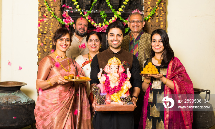 Indian family celebrating Ganesh festival with Ganesha Idol