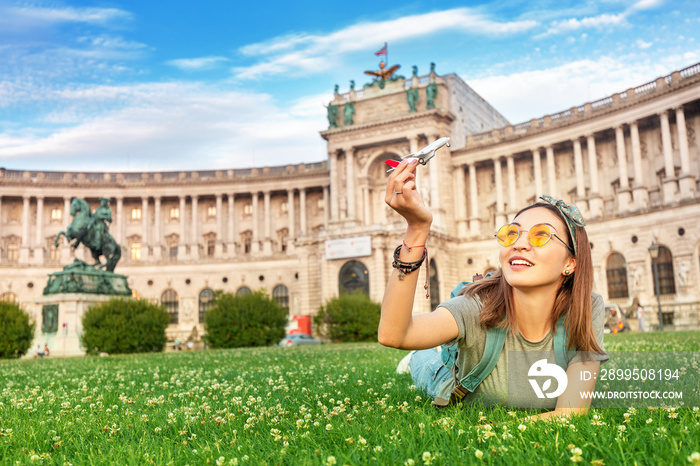 Happy asian girl on a grass lawn playing with toy airplane, as symbol of travelling and transportation for tourists.