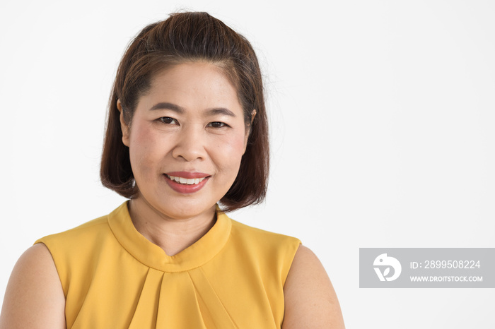 Portrait of middle aged Asian woman wearing yellow blouse smiling beautifully with confident isolated