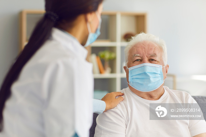 Woman doctor visits the elderly man and provides him with support during the quarantine.