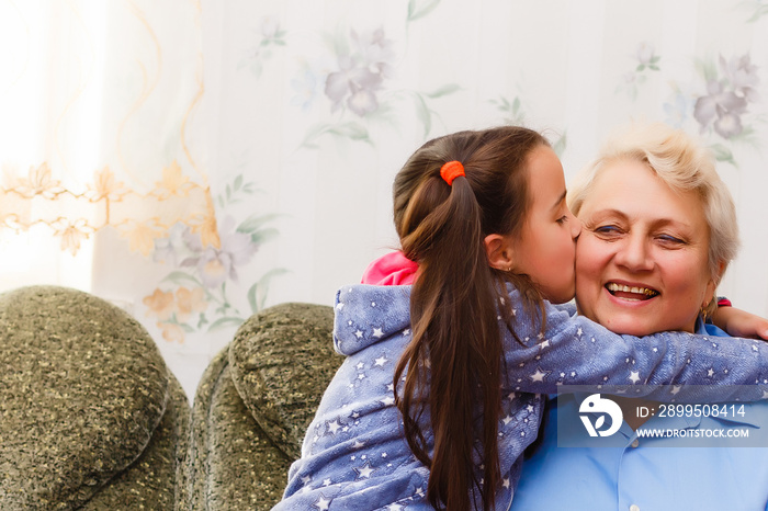 Grown up adult smiling grandchildren embraces elderly grandmother glad to see missing her, visit of loving relatives enjoy communication, cuddle as symbol of connection, love and support concept