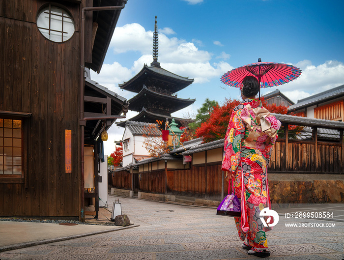 apanese girl walk in kyoto old market and wooded yasaka pagoda