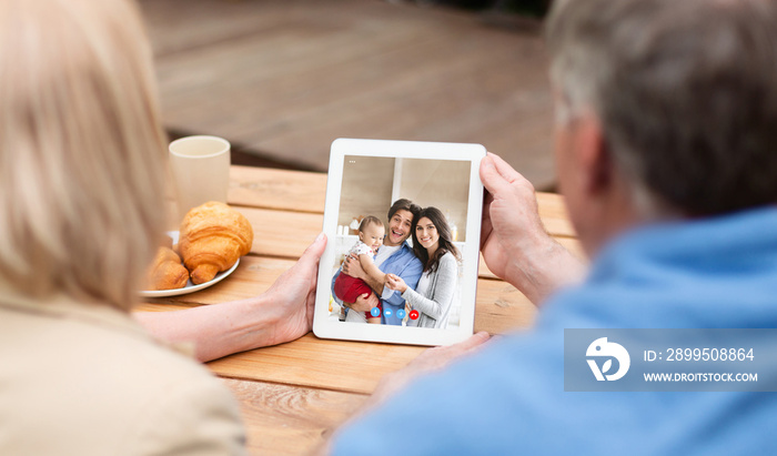 Online Meeting. Senior Couple Having Video Call With Children On Digital Tablet