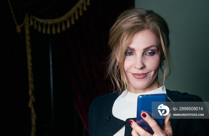 Portrait of a senior business woman wearing formal suit talking on a phone