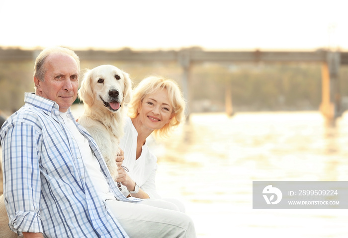 Senior couple and big dog on bund