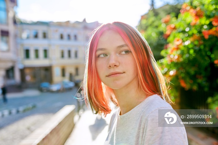 Outdoor portrait of girl 16, 17 years old on the street of sunny city, copy space