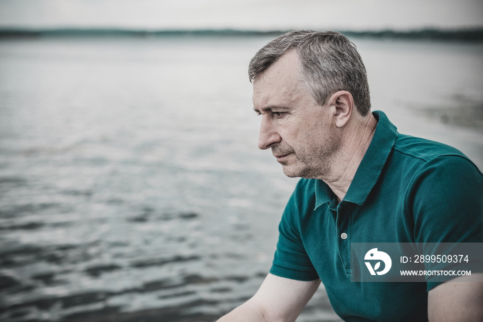 Contrast image of a sad mature man useful to illustrate stress, depression and alone sadness