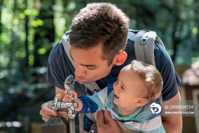 10 month old baby boy at water fountain with hispanic dad