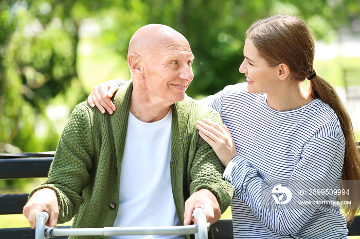 Elderly man with his daughter in park