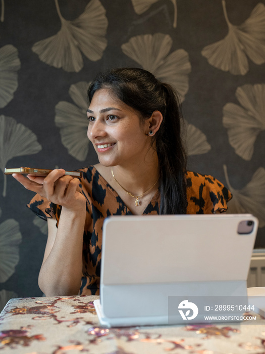 Woman working on tablet from home