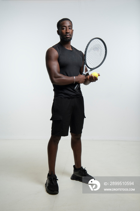 Man holding tennis ball and racket