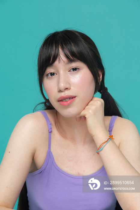 Studio portrait of pensive girl