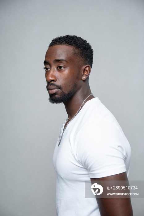 Portrait of man wearing white t-shirt and necklace