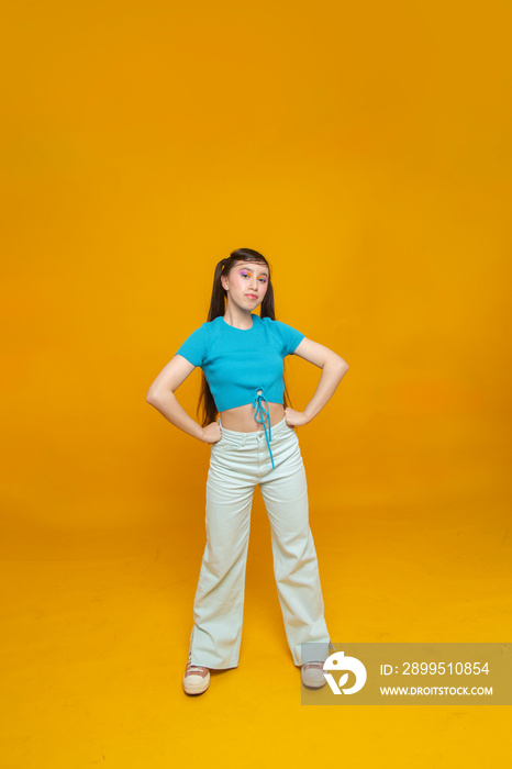 Studio portrait of girl with hands on hips