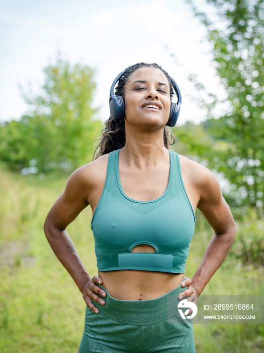 Portrait of woman exercising in meadow