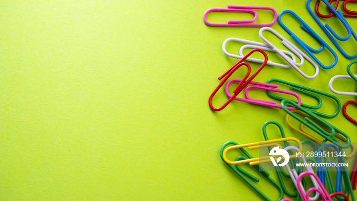 Color push pins on green background for copyspace. Concept of office administrator business, financial inspector or secretary. View from above with copy space