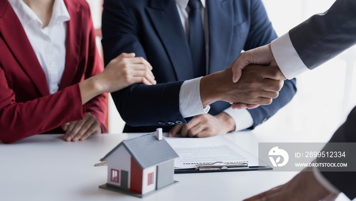 Happy couple first time home owners handshaking realtor insurer landlord bank worker at meeting, asian family customers make real estate deal for rent house purchase or mortgage investment