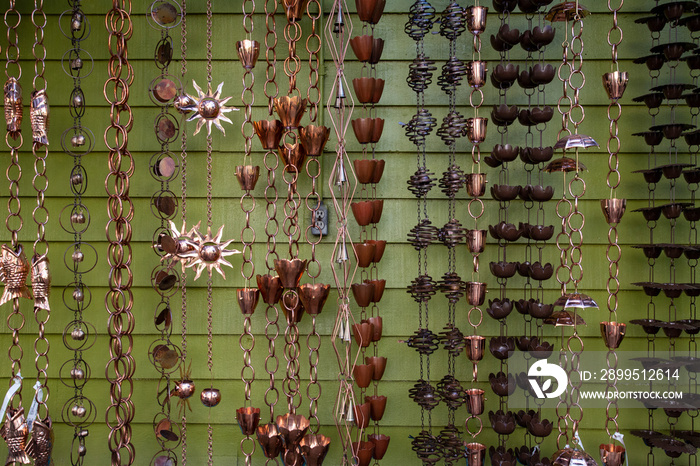 Isolated, close up view of a wall of decorative rain chains/rain catchers