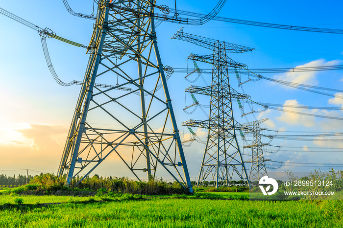 High voltage power tower industrial landscape at sunrise,urban power transmission lines.