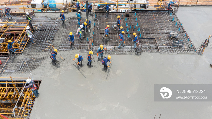 construction worker pouring concrete by pumping