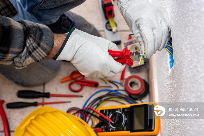 Electrician at work on a residential electrical system. Electricity.