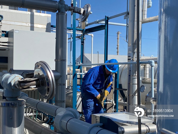 Industrial workers checking the temperatures at a LNG plant