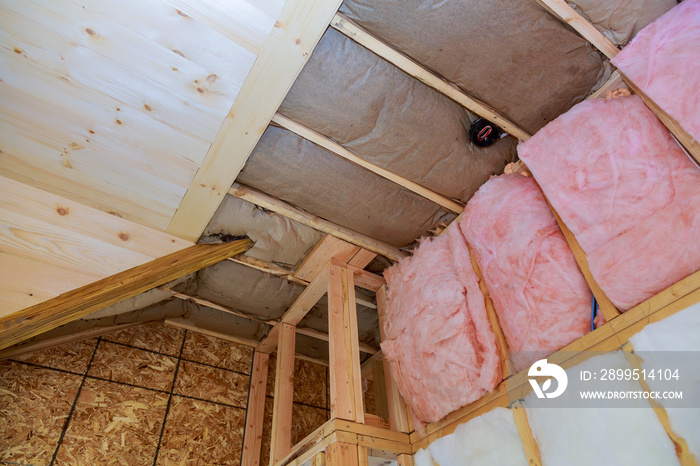 Covering view of layers of pink fiberglass insulation cold barrier