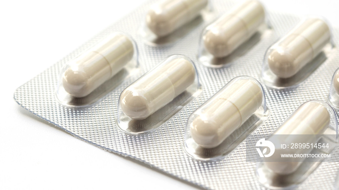 white pill capsule on a white background.