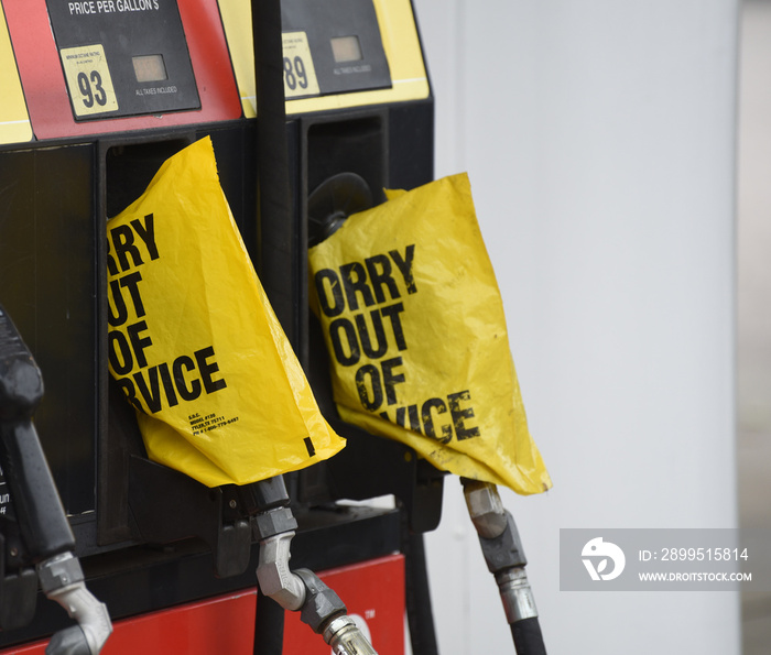 Empty pumps are marked with yellow bags reading  sorry out of service  as gas stations run out of supply.