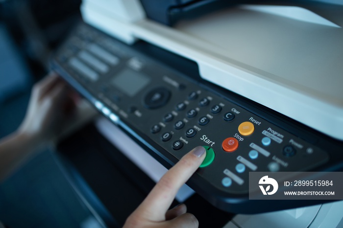 Hand on businesswoman using copy machine