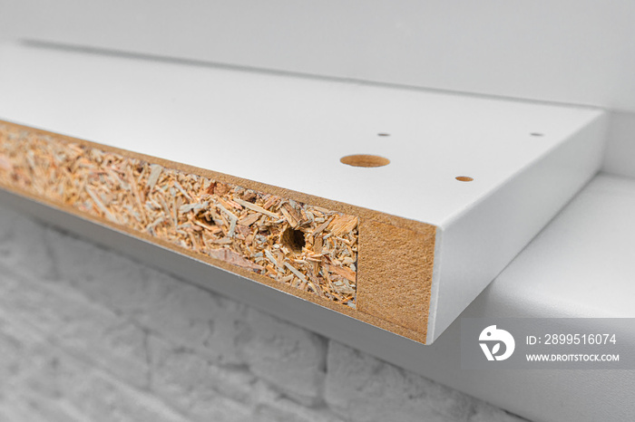 Section or end of the chipboard plate as a demonstration of the thermal insulation properties of the material