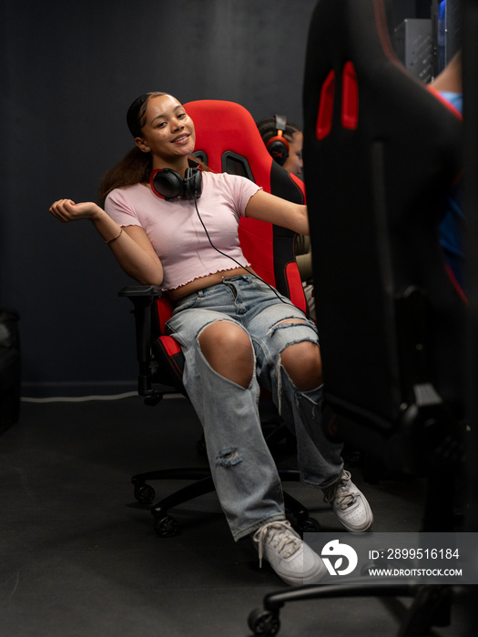 Portrait of young woman sitting on gaming chair