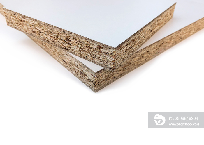 Wood chips and sawdust pressed into sheet material. On a white background with place for text. Uni color board. For the manufacture of cabinet furniture.