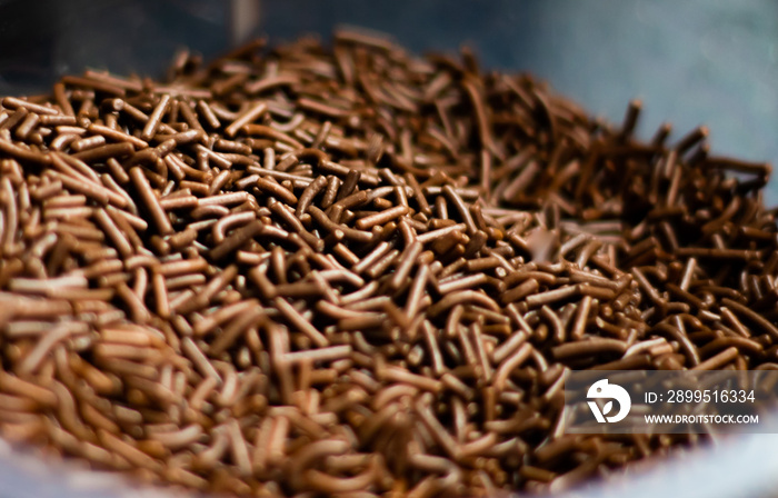 Chocolate sprinkles background ( chocolate granulado ), sweet food, candy. Ingredient used to make brigadeiro cake, pot cake and chocolate sweets. Selective focus, Close up