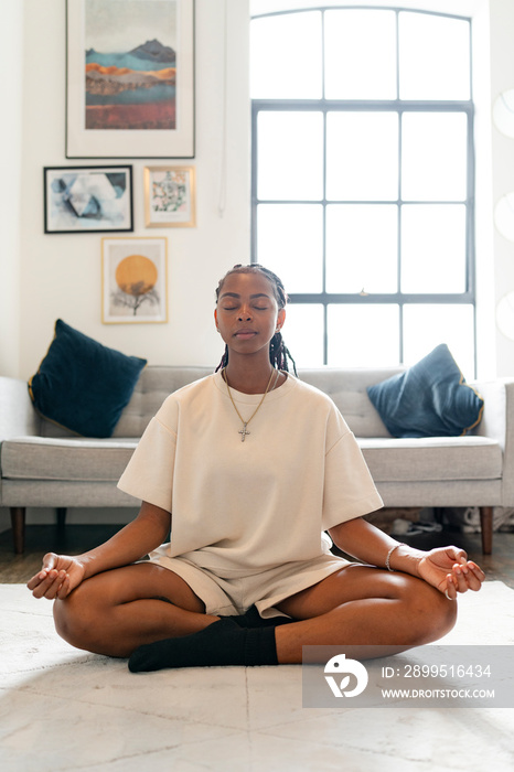 Young woman practicing yoga at home