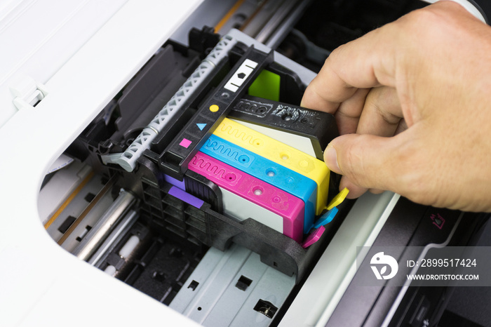 Technicians are install setup the ink cartridge of a inkjet printer the device of office automate for printing