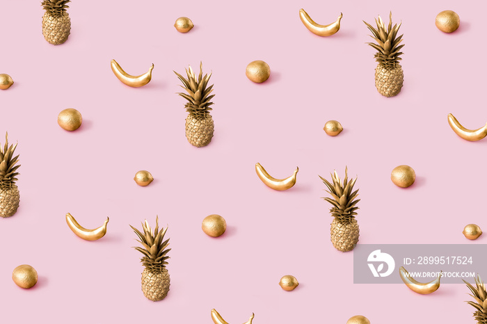 Golden sunlight summer pattern made with tropical summer fruits on pastel pink background. Trendy abstact creative concept.