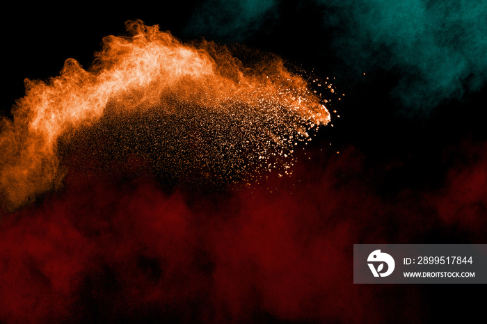 Abstract color powder explosion on black background.Freeze motion of dust splash. Painted Holi in festival.