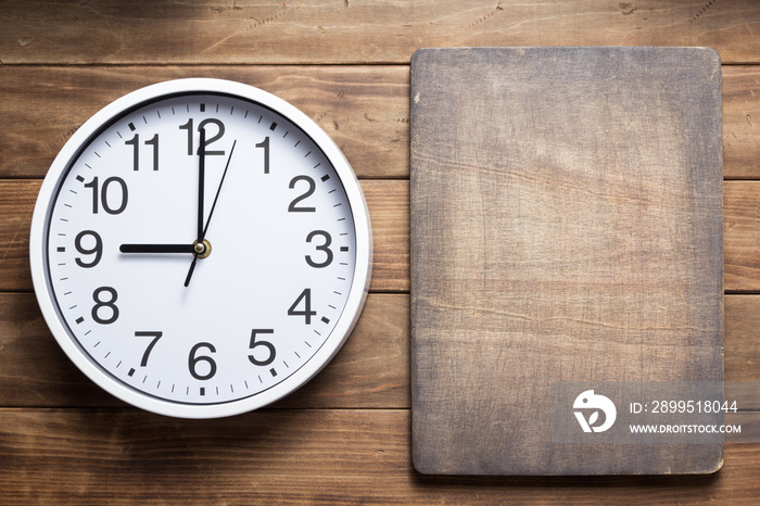 wall clock at wooden background