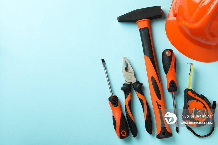 Work tools on blue background, top view