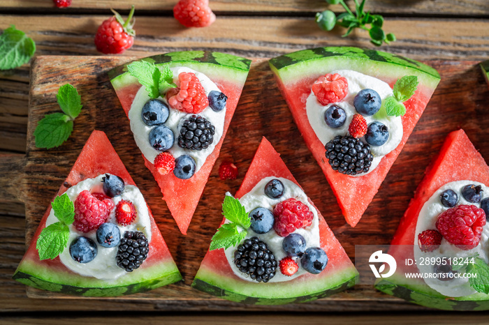 Sweet watermelon pizza with blueberries, raspberries and cream