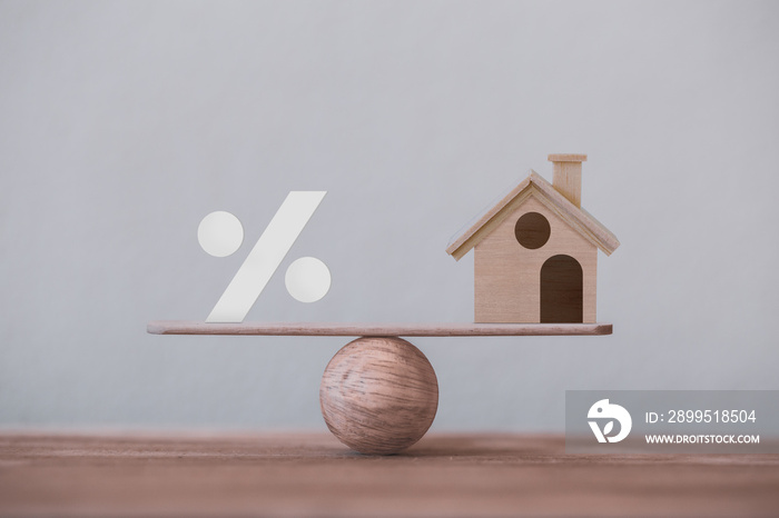 Percentage symbol icon and house scale in equal position. financial management concept : depicts short term borrowing for a residence.