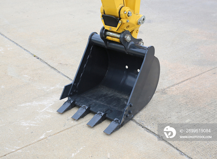 Excavator bucket on cement ground, Industrial excavator machine